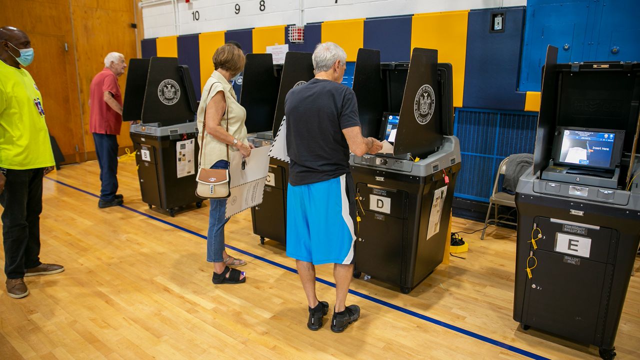 People vote at the Anning S. Prall Intermediate School on Staten Island on Tuesday, June 28, 2022. (AP Photo/Ted Shaffrey)