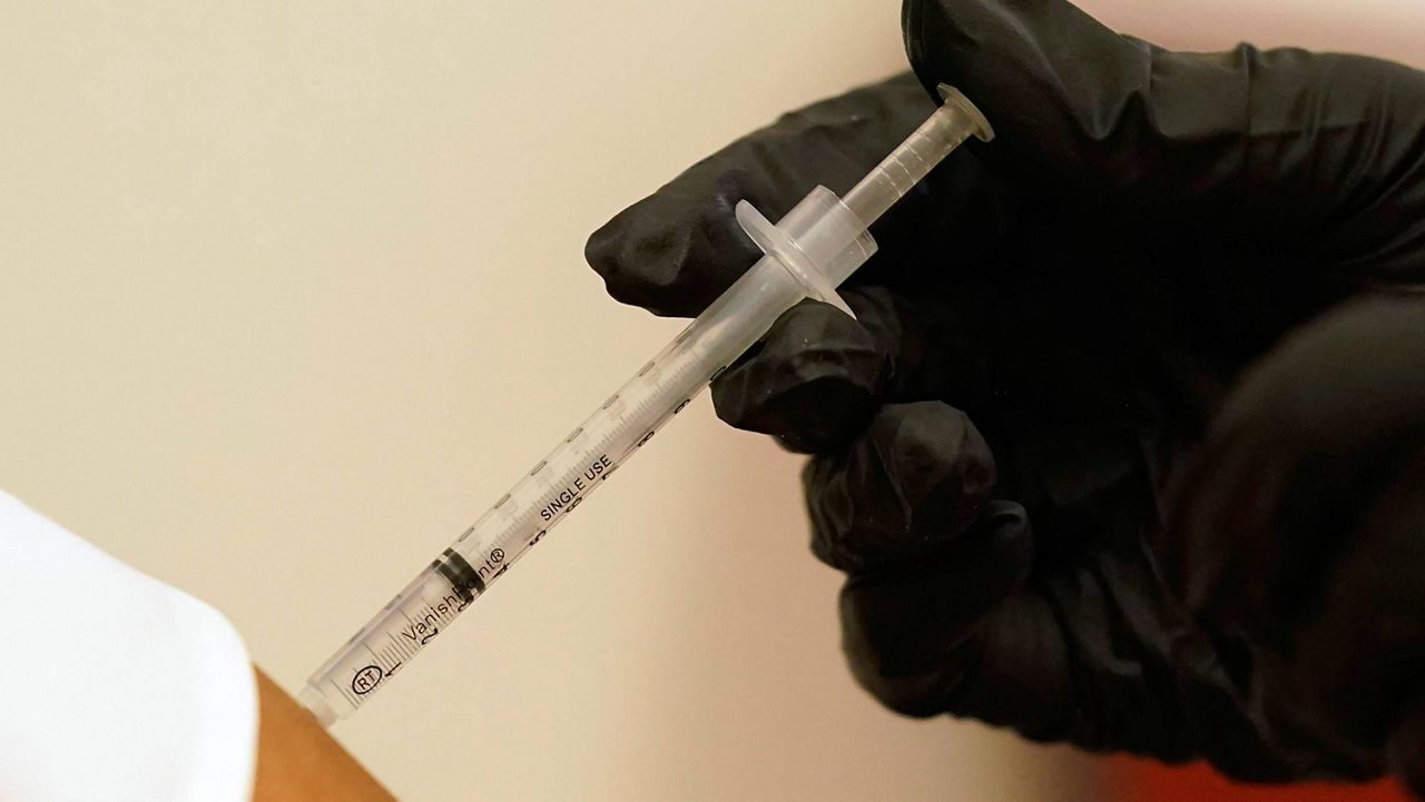 A person is injected with Pfizer's COVID-19 vaccine. (AP Photo/LM Otero, File)
