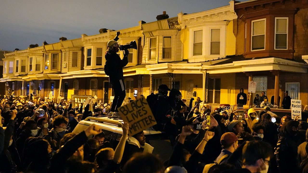 Protesters confront police during a march Tuesday in Philadelphia. (AP Photo/Matt Slocum)