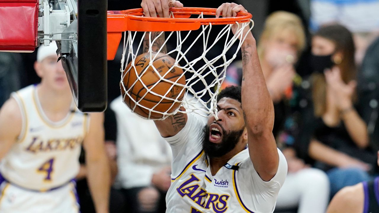 Los Angeles Lakers forward Anthony Davis dunks against the Phoenix Suns during the first half of Game 1 of their NBA basketball first-round playoff series Sunday, May 23, 2021, in Phoenix. (AP Photo/Ross D. Franklin)