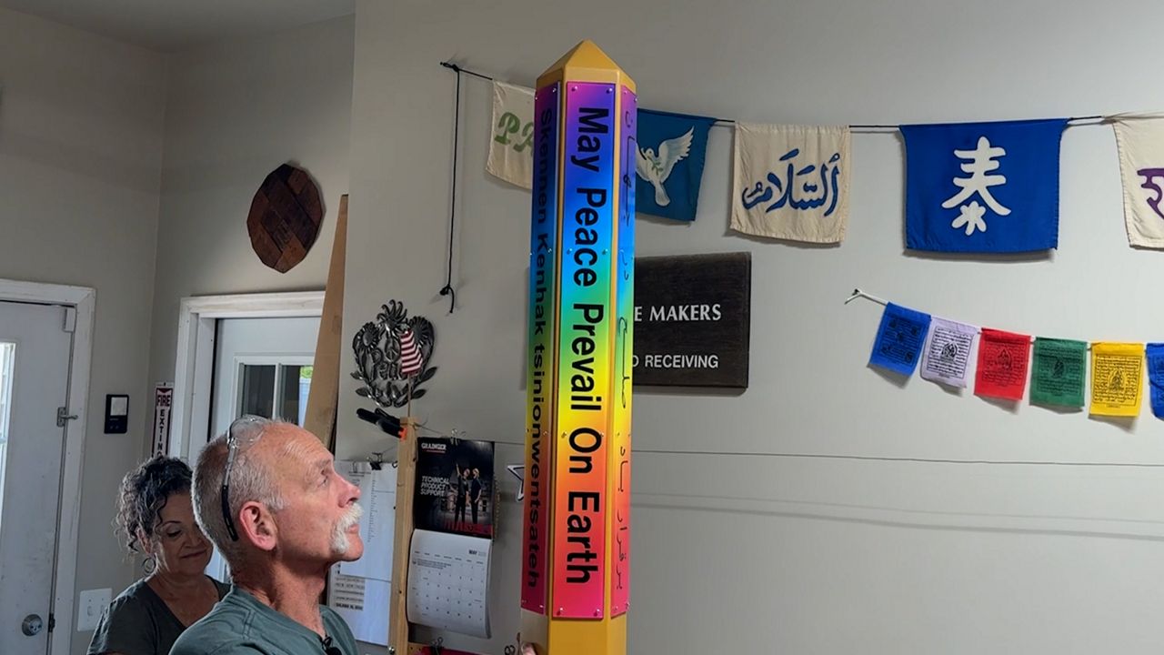 Tim Law shows off a Peace Pole