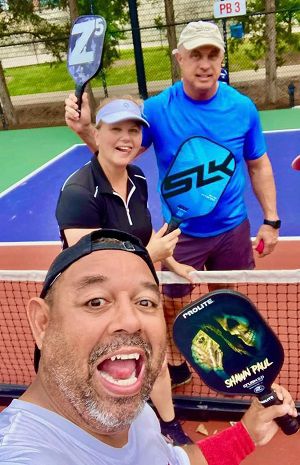 Lori Hogenkamp (back, left) poses for a photo with her partner Barry Frink (back, right) and another pickleball player. (Photo courtesy of Lori Hogenkamp)