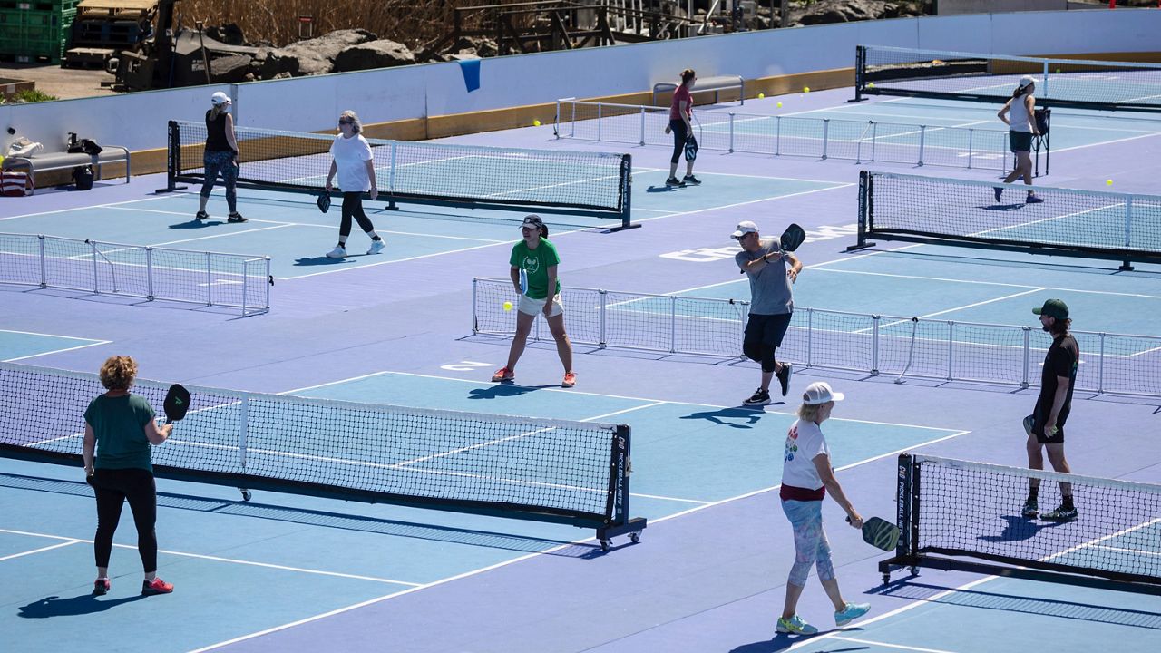 People play pickleball at Wollman Rink at Central Park in New York on Wednesday, April 12, 2023.