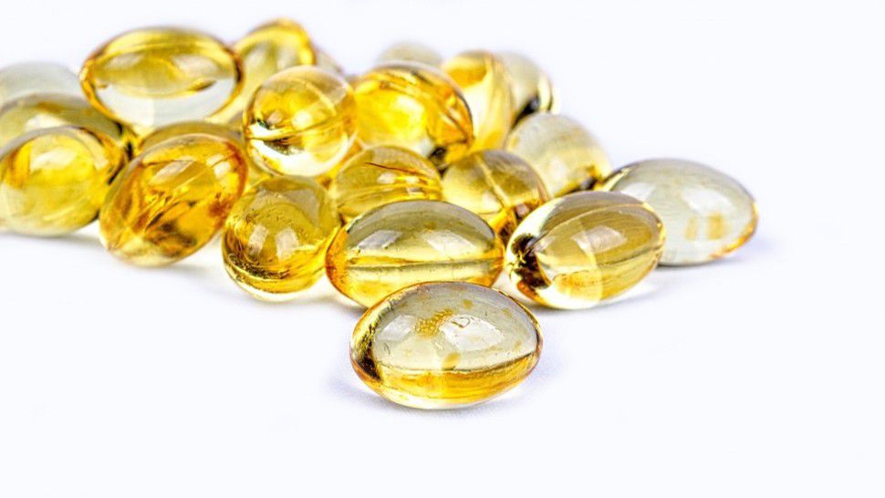 Yellow vitamin pills appear in this stock image. (Pixabay)
