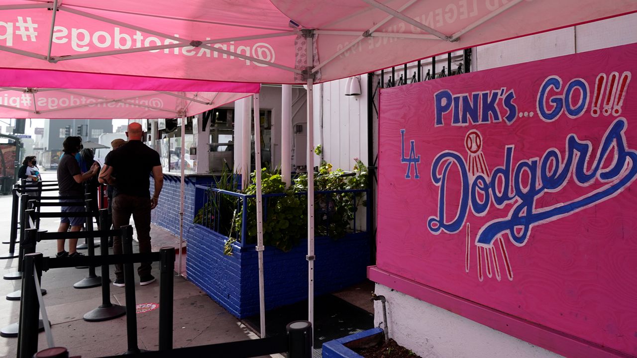 Pink's Hot Dogs is decorated in Dodgers blue in support of the Los Angeles Dodgers, who are playing in the 2020 World Series against the Tampa Bay Rays Wednesday, Oct. 21, 2020, in Los Angeles. Due to the spread of COVID-19, all of the 2020 World Series games will be played in Arlington, Texas. (AP Photo/Ashley Landis)