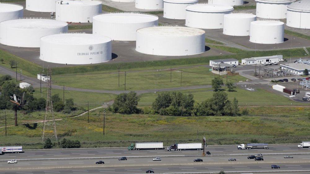 FILE - In this Sept. 8, 2008 file photo traffic on I-95 passes oil storage tanks owned by the Colonial Pipeline Company in Linden, N.J. (AP Photo/Mark Lennihan, File)