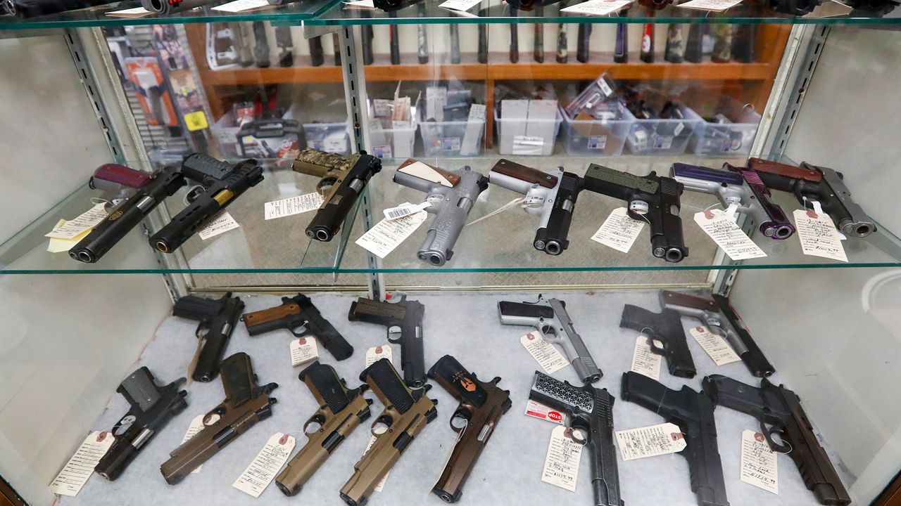 Semi-automatic handguns are displayed at a shop. (AP Photo/Keith Srakocic)  