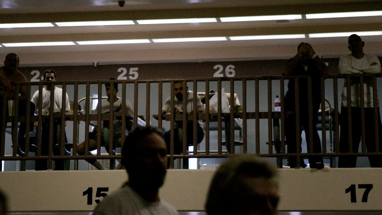 White inmates listen to clergy members, (not in the frame), Thursday, Feb. 9, 2006, about the conflict between Blacks and Latinos at the Pitchess Detention Center in Castaic, 40 miles north of downtown Los Angeles. (AP Photo/Ric Francis)
