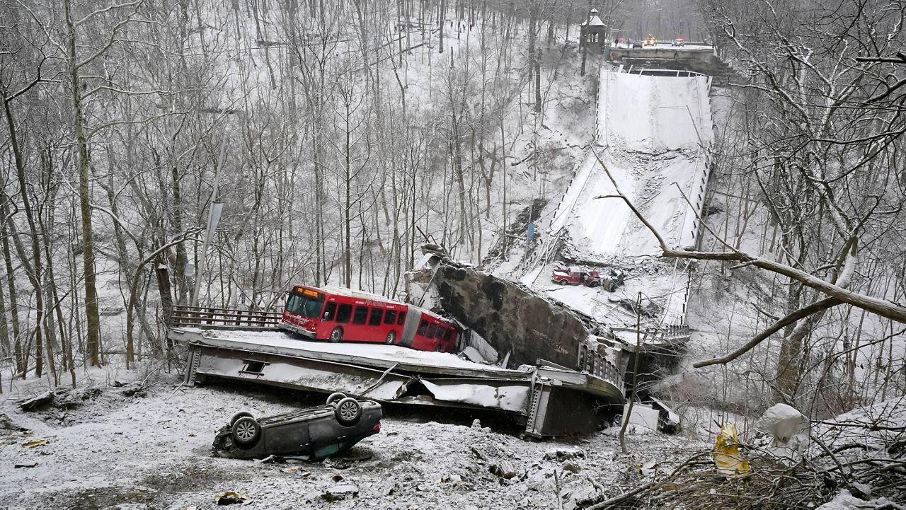 A Port Authority bus that was on a bridge when it collapsed Friday is visible in Pittsburgh's East End. (AP Photo/Gene J. Puskar)