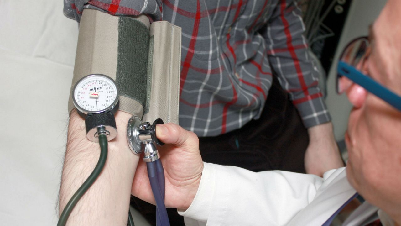 Stock image of a doctor checking the blood pressure of a patient. (Pixabay)