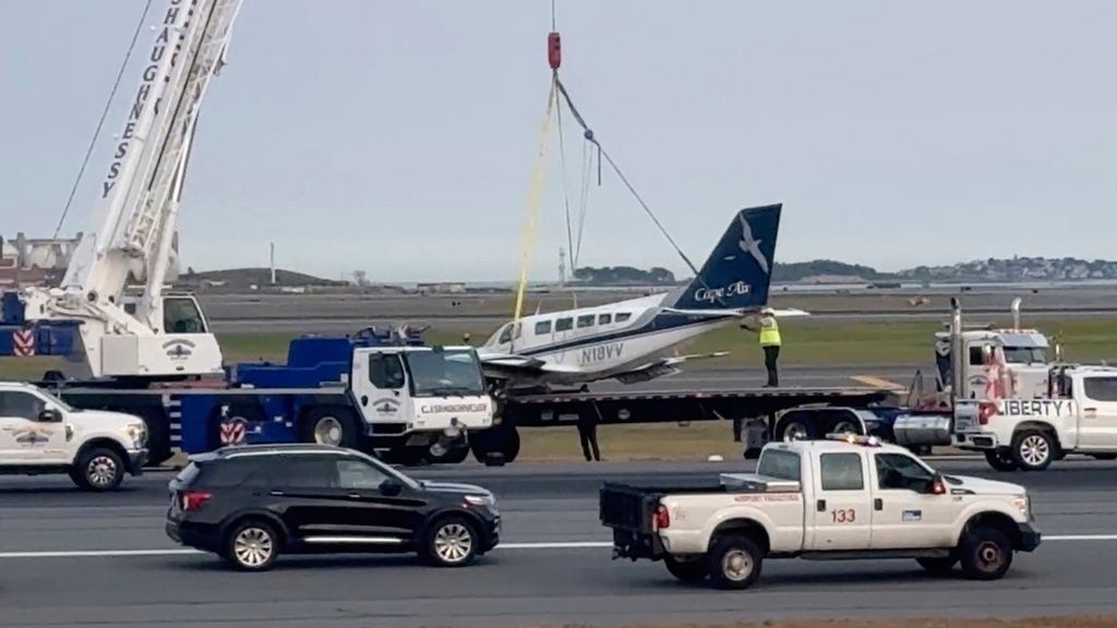 In this image made from video, officials remove a small plane that landed at Logan International Airport after having only one of its landing wheels deploy, Tuesday, Sept. 17, 2024, in Boston. (AP Photo/Rodrique Ngowi)