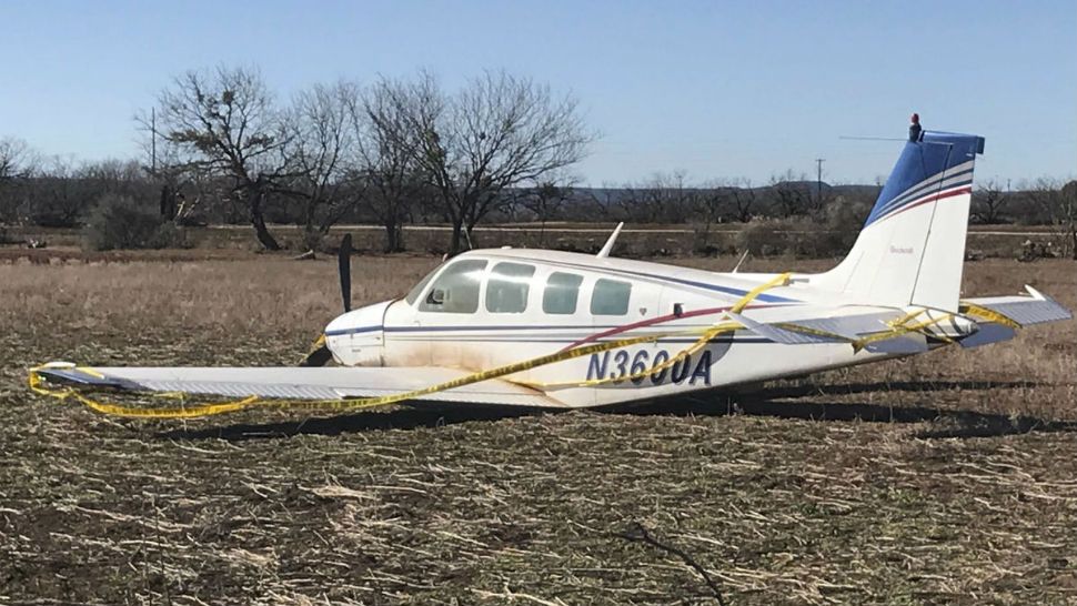 A single-engine private plane rests on it belly after a crash landing Monday, Jan. 22, 2018, in a West Texas field shortly after takeoff from Abilene Regional Airport in Abilene, Texas. Taylor County Sheriff's Sgt. Cliff Griffin says the pilot wasn't hurt in the crash The area is about a mile west of  Dyess Air Force Base. (Timothy Chipp/Abilene Reporter-News via AP)