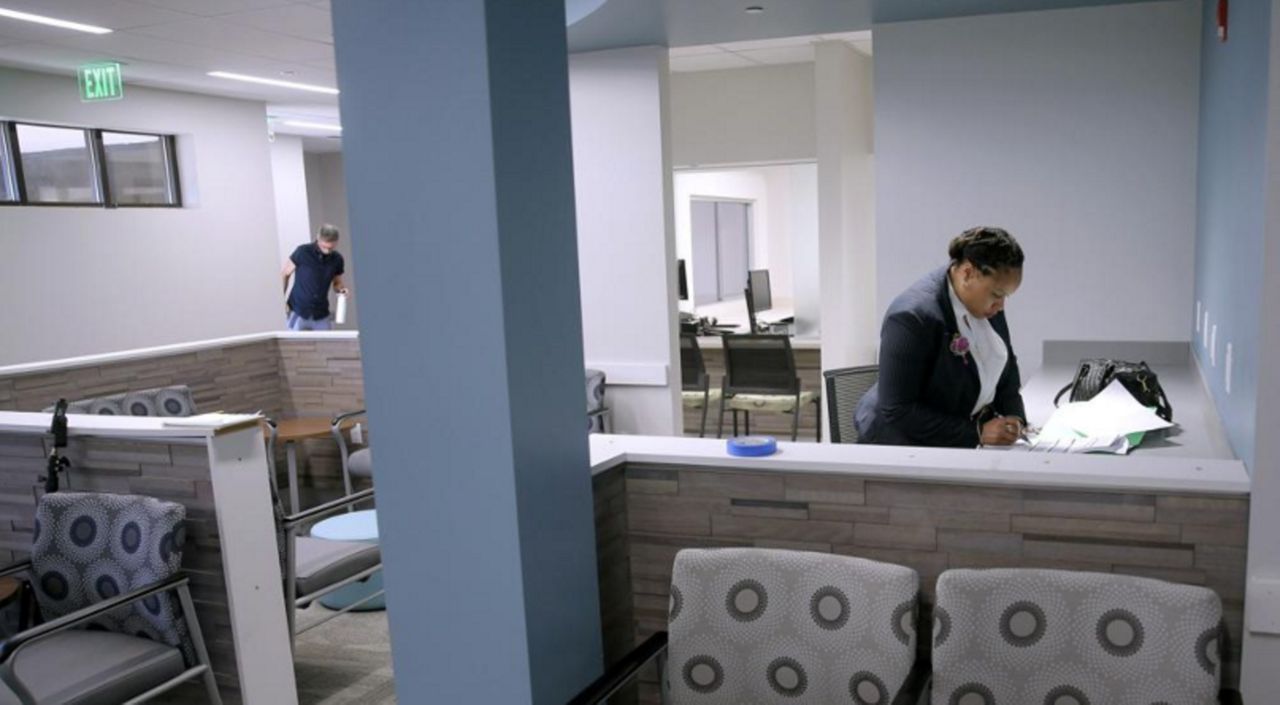 FILE - Anita Murphy, a Planned Parenthood executive, does paperwork in the waiting room during a media tour of the new Fairview Heights, Ill., facility on Oct. 2, 2019, prior to open that month. With abortion access increasingly restricted across much of the South and Midwest, two Illinois clinics near St. Louis on Friday, Jan. 21, 2022, announced a new logistics center to help abortion seekers get to their clinics. (Christian Gooden/St. Louis Post-Dispatch via AP, File)