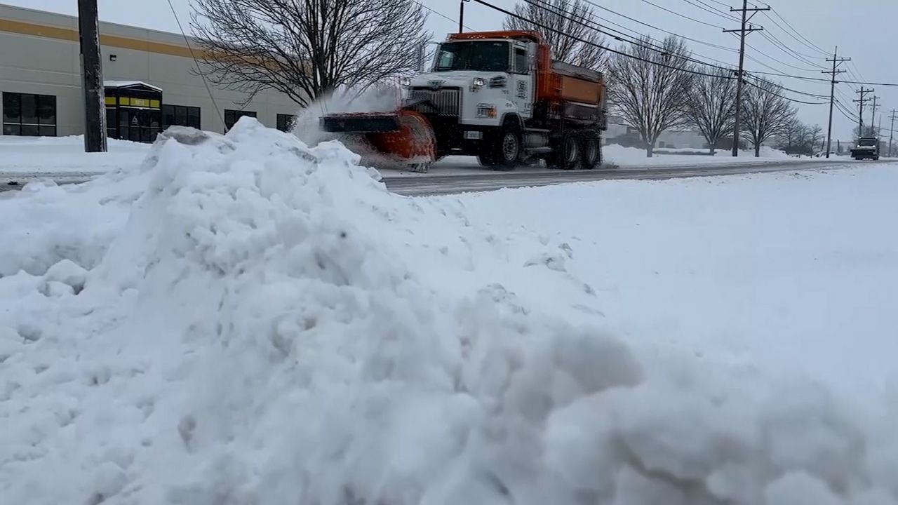 A snow plow on the road.