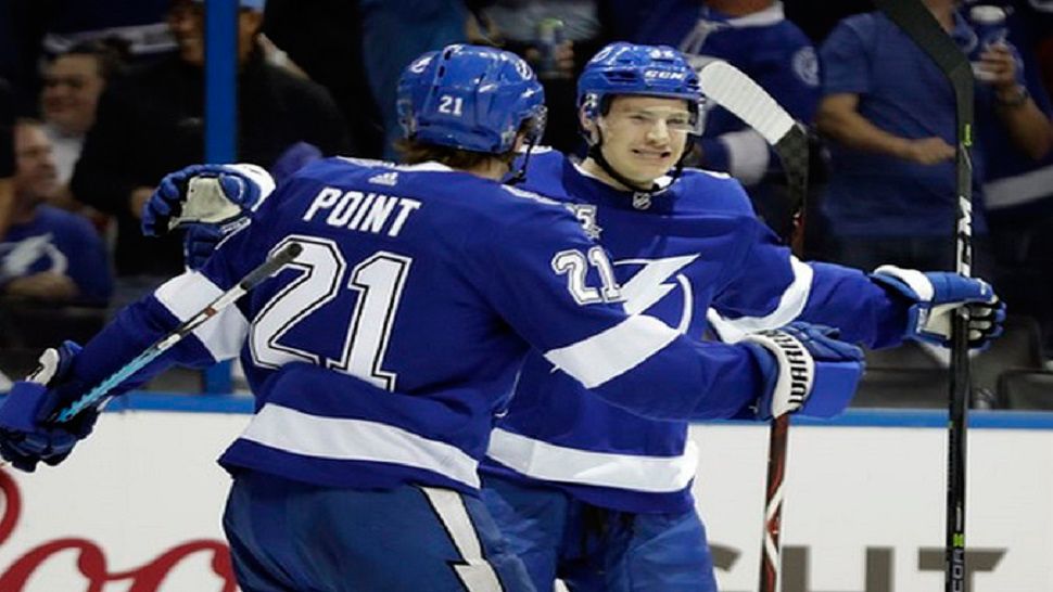 Tampa Bay Lightning center Yanni Gourde, right, celebrates his goal against the New Jersey Devils with center Brayden Point during the second period of Game 1 of their playoff opener. Chris O'Meara - AP Photo 