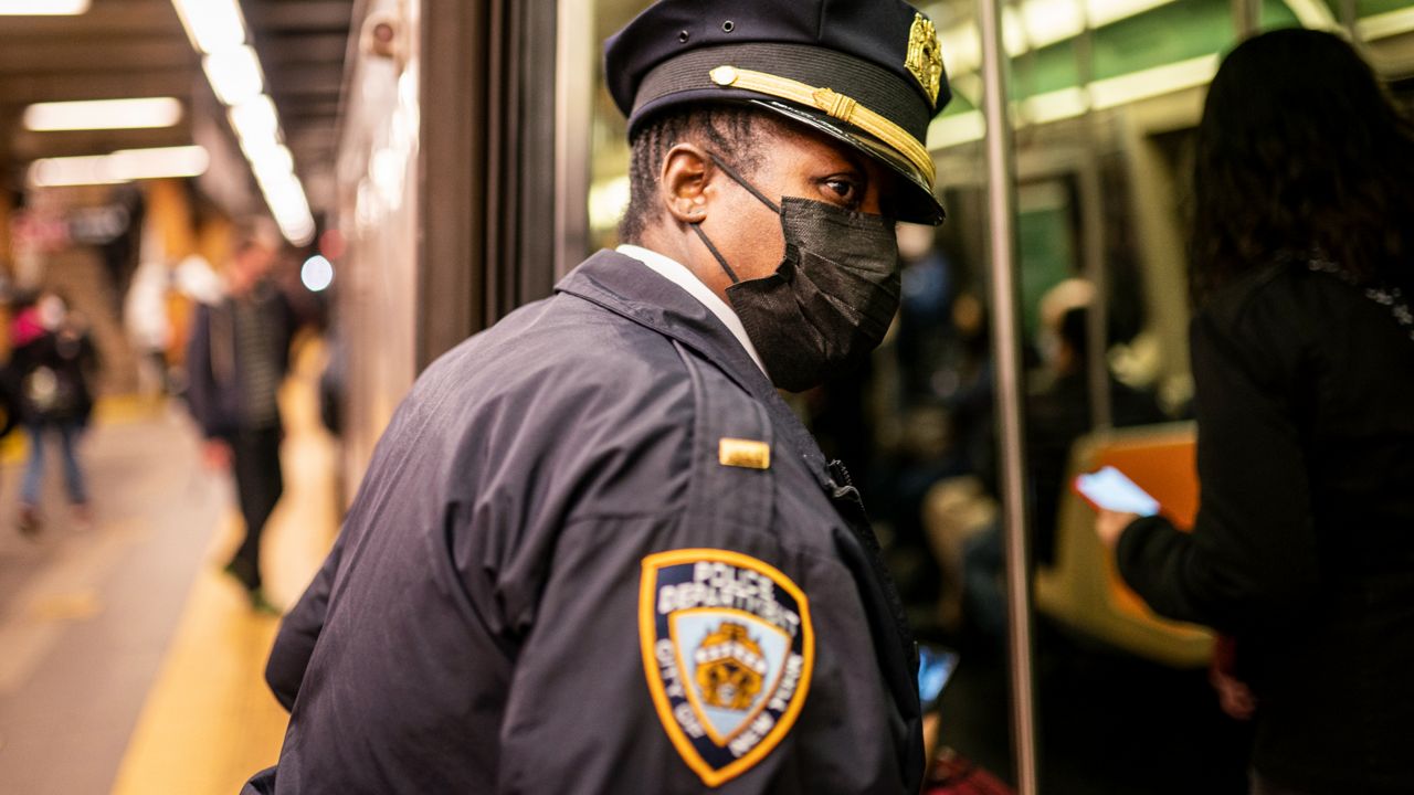 NYPD officers patrol platforms and train cars at the 36th Street subway station where a shooting attack occurred the previous day during the morning commute, Wednesday, April 13, 2022. (AP Photo/John Minchillo)