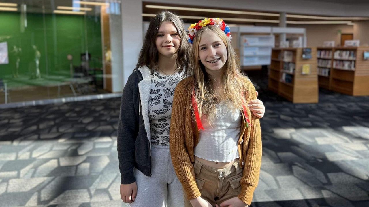 Polina Fedenko (L) poses for a picture with a new friend she met during an open house for Ukrainian refugees this November. (Photo courtesy of Maryna Braginsky)