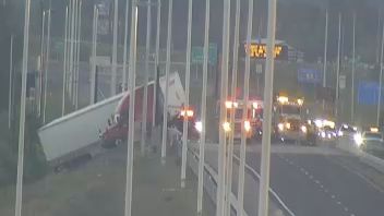 A semi-truck hangs over a highway barrier on Polk Parkway East. (Florida Department of Transportation)