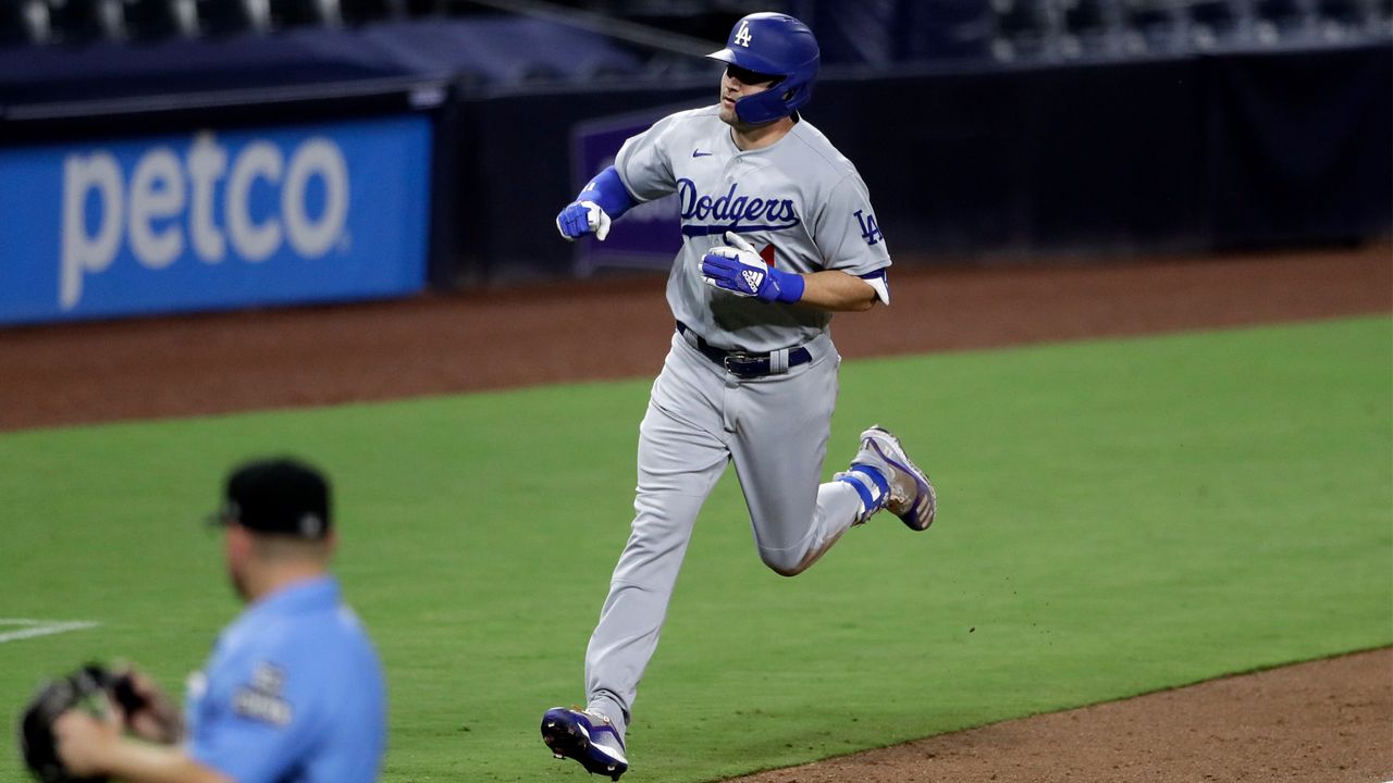 Los Angeles Dodgers left fielder A.J. Pollock reacts after hitting a home run during the ninth inning of the team's baseball game against the San Diego Padres, Tuesday, Aug. 4, 2020, in San Diego. (AP Photo/Gregory Bull)