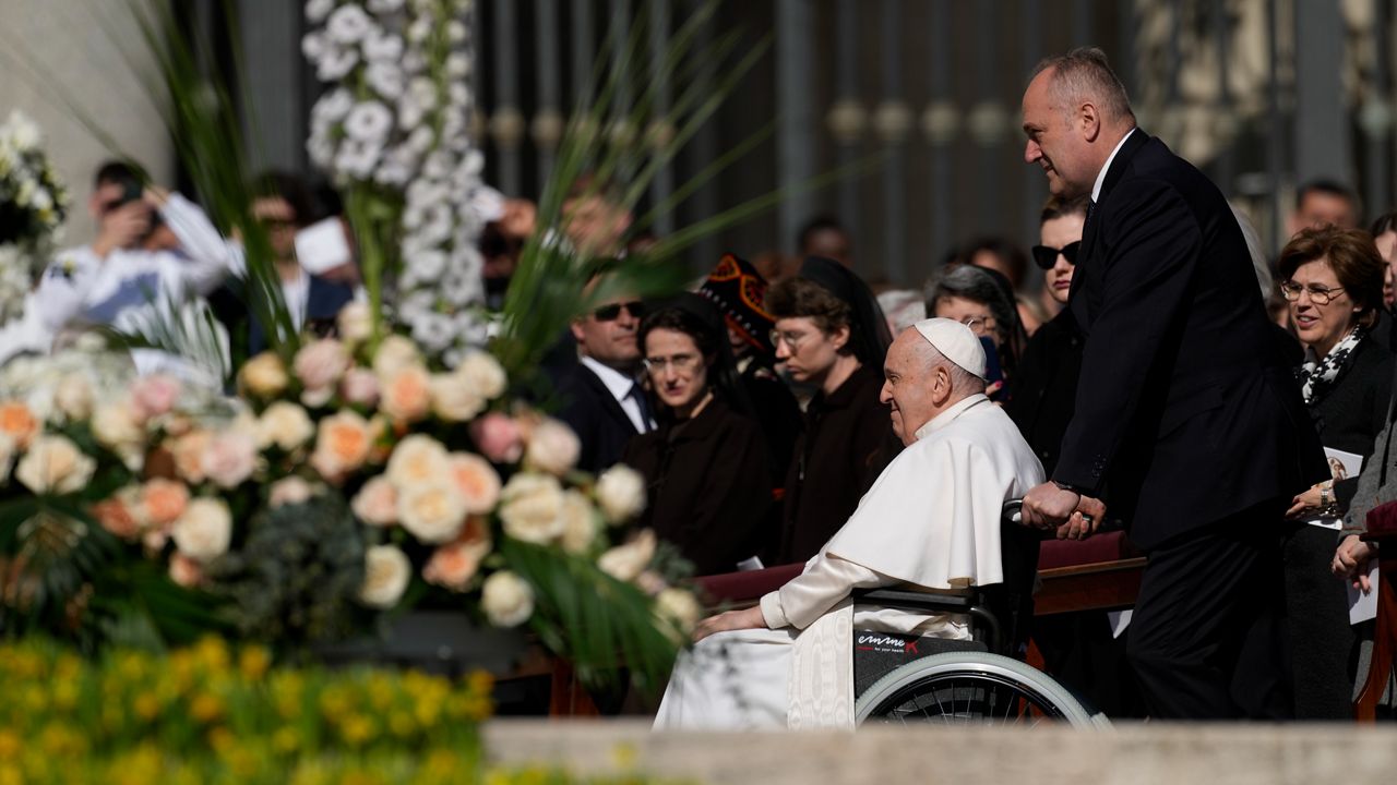 Pope Francis arrives in a wheelchair in St. Peter's Square at The Vatican where he will celebrate the Easter Sunday mass, Sunday, April 9, 2023. (AP Photo/Alessandra Tarantino)