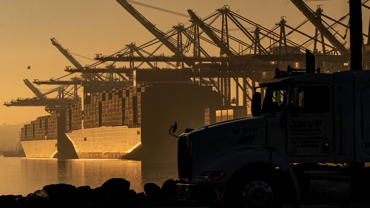 A truck arrives to pick up a shipping container near vessels moored at Maersk APM Terminals Pacific at the Port of Los Angeles, Nov. 30, 2021. (AP Photo/Damian Dovarganes)