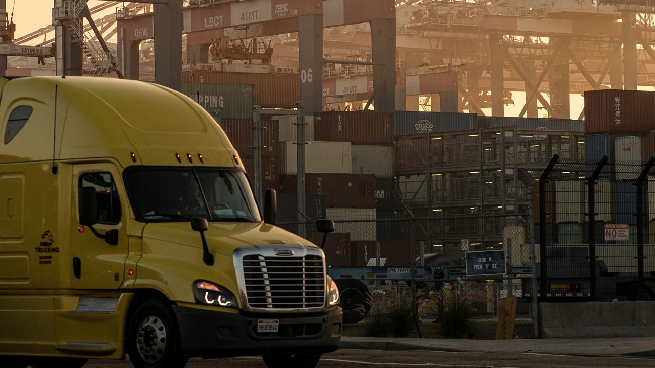 A truck drives out of the Long Beach Container Terminal in Long Beach, Calif., Tuesday, Nov. 30, 2021. 