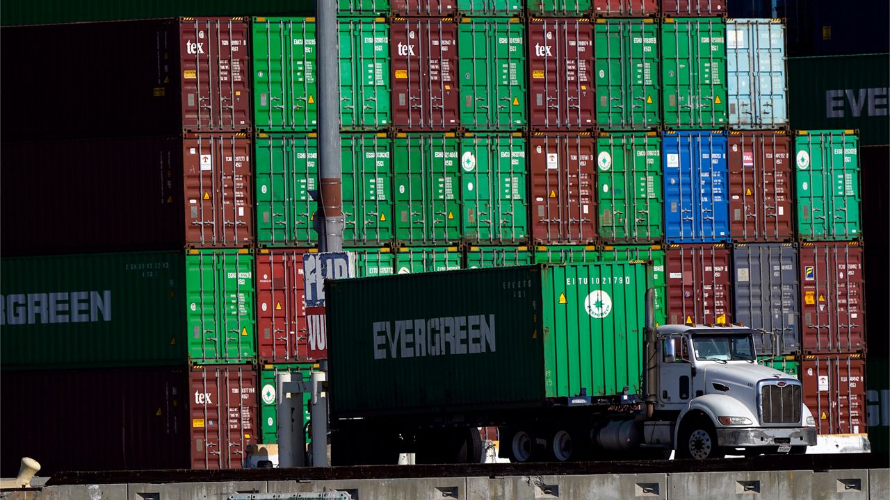 Shipping containers are stacked over a truck at the Port of Los Angeles, Nov. 10, 2021, in Los Angeles. (AP Photo/Marcio Jose Sanchez)