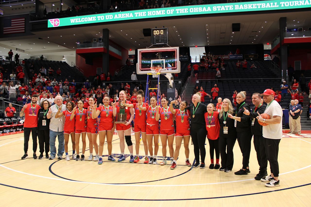 The Portsmouth High School girls basketball team holds up '1' following their first state title win after the OHSAA Girls State Championship at UD Arena on Saturday.