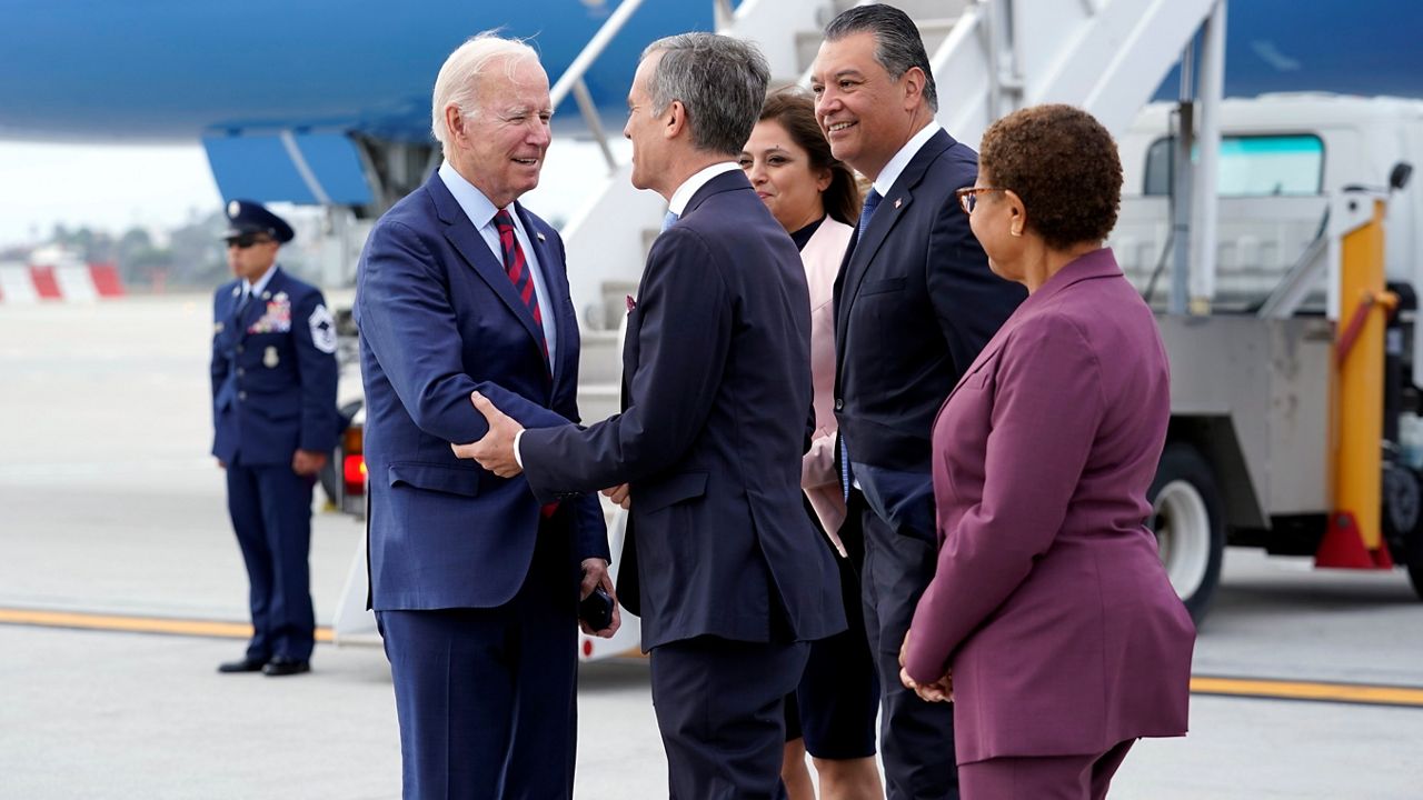 President Joe Biden greets then-Los Angeles Mayor Eric Garcetti, Sen. Alex Padilla, D-Calif., and his wife Angela Padilla and then-Rep. Karen Bass, D-Calif., after arriving on Air Force One at Los Angeles International Airport, Wednesday, Oct. 12, 2022. (AP Photo/Carolyn Kaster)