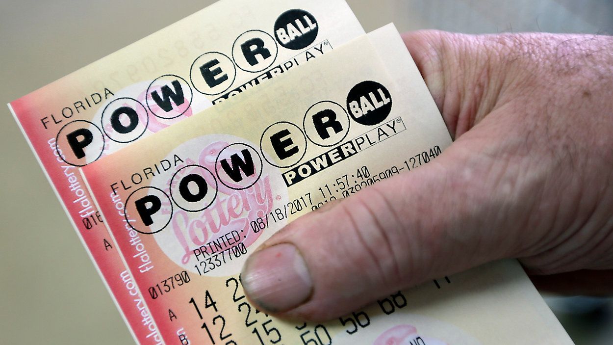 Customers pay for their groceries next to the lottery ticket display showing the jackpot amount for the Saturday, Oct. 29, drawing of the Powerball lottery at a market in Prospect, Pa., Friday, Oct. 28, 2022. Saturday's jackpot projected winnings of an estimated $825 million is the fifth-highest in U.S. history. (AP Photo/Keith Srakocic)