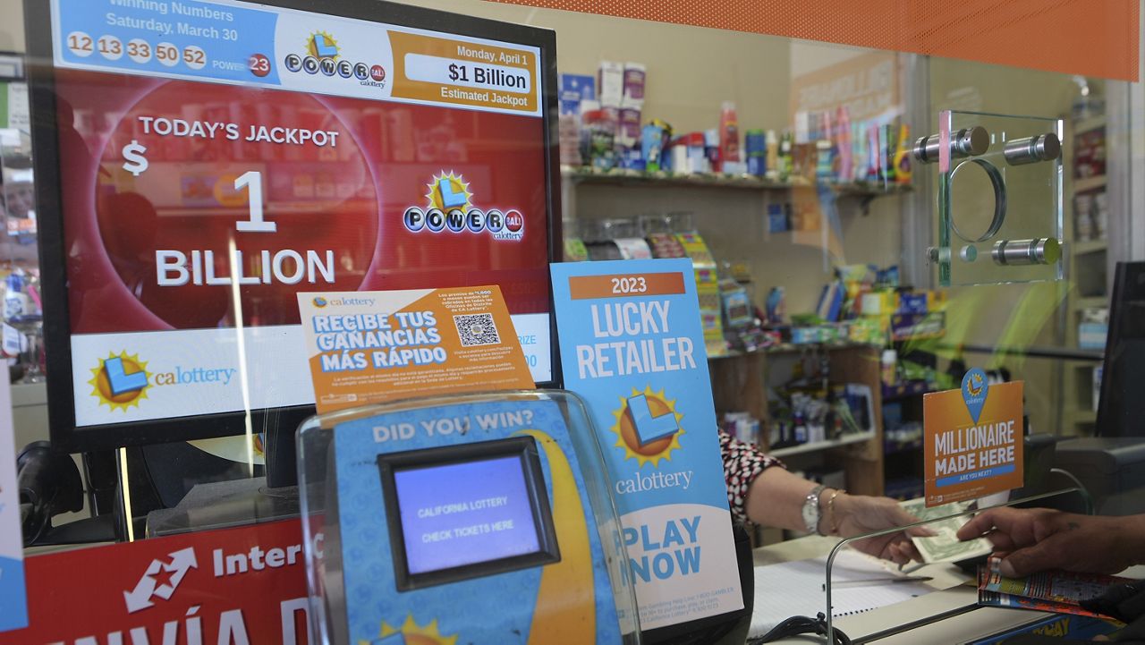 Lottery players buy Powerball tickets at the Las Palmitas Mini Market in in the Fashion District downtown Los Angeles on Monday, April 1, 2024. (AP Photo/Damian Dovarganes)