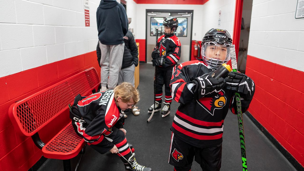 #10 Mason Anderson (left), #88 Max Randall (center) and Naeol Ryu (right) prepare for hockey practice (Spectrum News 1/Mason Brighton)