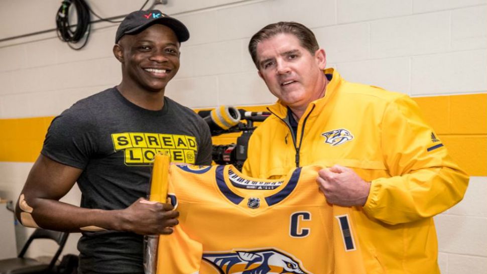 James Shaw Jr., left, and Nashville Predators head coach Peter Laviolette pose with a customized Predators jersey in this image from April 29, 2018. (Nashville Predators/Twitter)