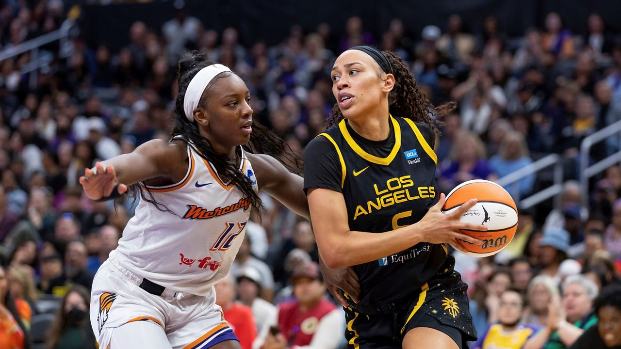 Los Angeles Sparks forward Dearica Hamby (5) drives to the basket while being guarded by Phoenix Mercury forward Michaela Onyenwere (12) during a WNBA basketball game May 19, 2023, in Los Angeles. (AP Photo/Jeff Lewis, File)
