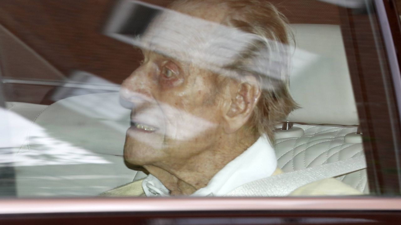 Prince Philip leaves the King Edward VII hospital in the back of a car in London on Tuesday. (AP Photo/Alastair Grant)