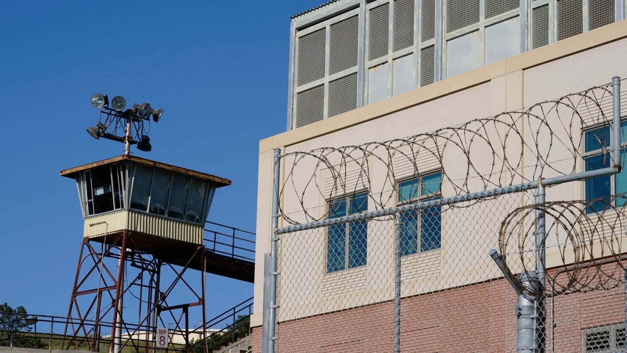 Barbed wire and a guard tower is seen at San Quentin State Prison on April 12, 2022, in San Quentin, Calif. (AP Photo/Eric Risberg, File)
