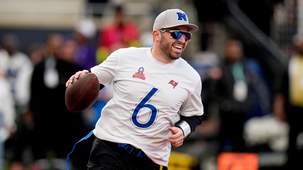 NFC quarterback Baker Mayfield, of the Tampa Bay Buccaneers, scrambles against the AFC during the flag football event at the NFL Pro Bowl football game, Sunday, Feb. 4, 2024, in Orlando. (AP Photo/Chris O'Meara)