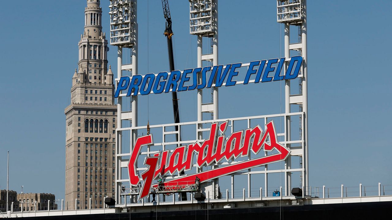 Workers finish installing the Cleveland Guardians sign above the scoreboard at Progressive Field, Thursday, March 17, 2022, in Cleveland(AP Photo/Ron Schwane, File)