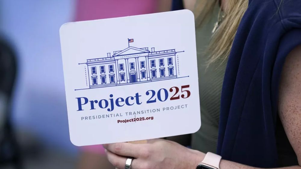 A Project 2025 fan is held by a supporter in the group’s tent at the Iowa State Fair in August 2023. (Associated Press/Charlie Neibergall)