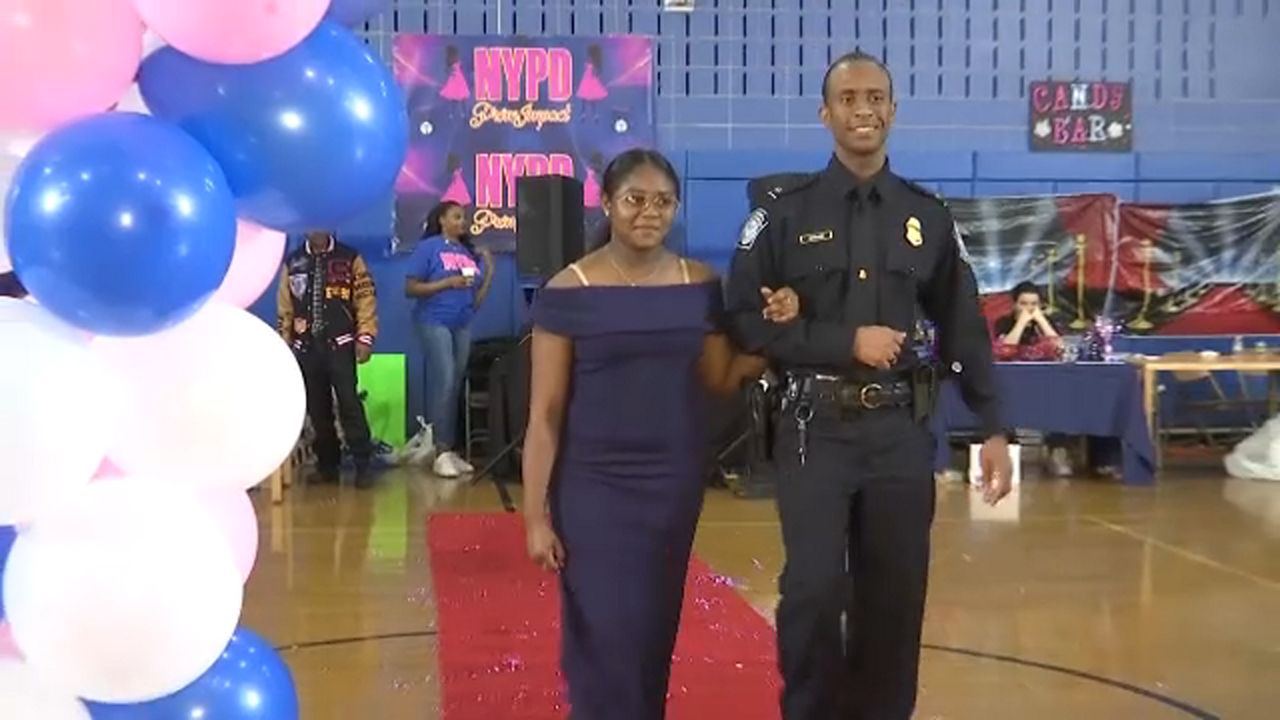 The teens walked down the red carpet with an officer in their dresses