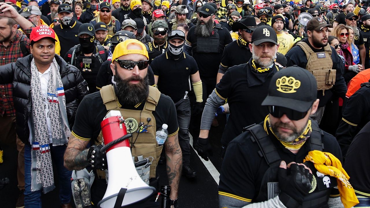 Far-right Proud Boys member Jeremy Joseph Bertino, second from left, joins other supporters of President Donald Trump who are wearing attire associated with the Proud Boys as they attend a rally at Freedom Plaza, Dec. 12, 2020, in Washington. (AP Photo/Luis M. Alvarez, File)