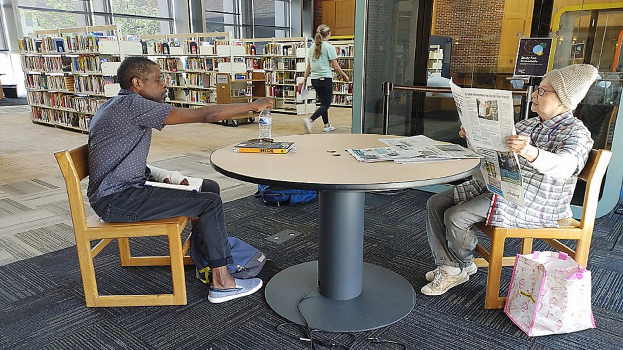 Cincinnati Public Library Regulars Eddie and Mercedes cool off during the heatwave. 
