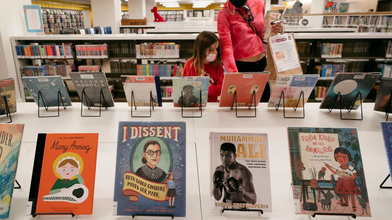 A young girl and her mother browse for books in the children's section of the Stavros Niarchos Foundation Library in New York. (AP Photo/Mark Lennihan)