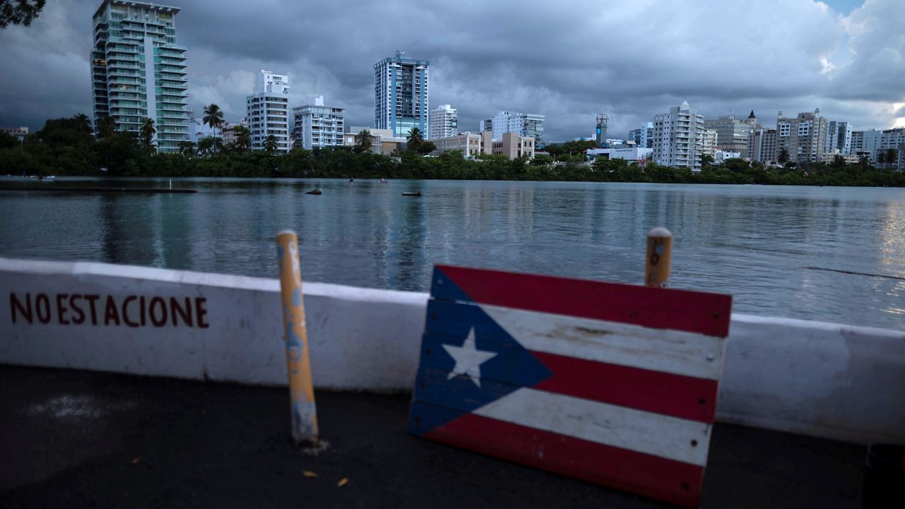 A wooden Puerto Rican flag is displayed on the dock of the Condado lagoon, where multiple selective blackouts have been recorded in the past days, in San Juan, Puerto Rico, Thursday, Sept. 30, 2021. (AP Photo/Carlos Giusti)