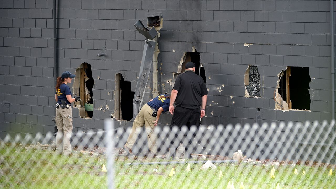 Law enforcement officials investigate behind Pulse nightclub after the 2016 shooting. (Phelan Ebenhack/AP)