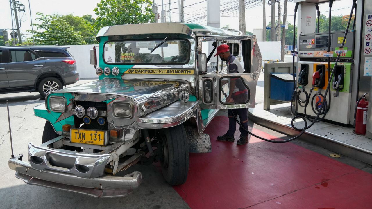 A man refuels his vehicle at a gas station in Quezon City, Philippines on Monday. (AP Photo/Aaron Favila)