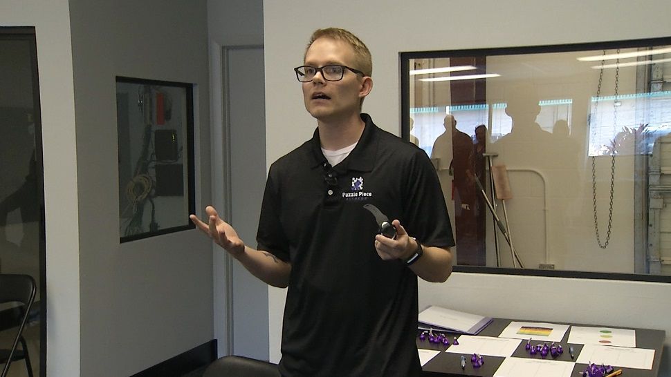 Puzzle Piece Fitness owner Mark Fleming explains a heart monitor to potential clients.