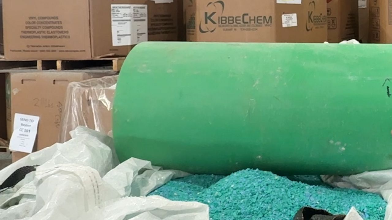 A PVC pipe and ground up PVC material 