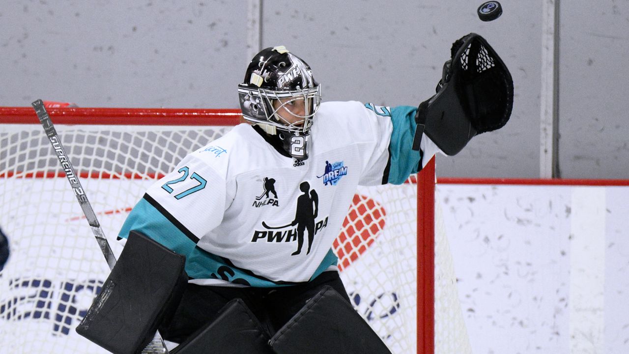 Team Sonnet goalie Erica Howe reaches for the puck during the first period of a hockey game against Team Bauer as part of the Secret Dream Gap Tour on Friday, March 4, 2022, in Arlington, Va. (AP Photo/Nick Wass)