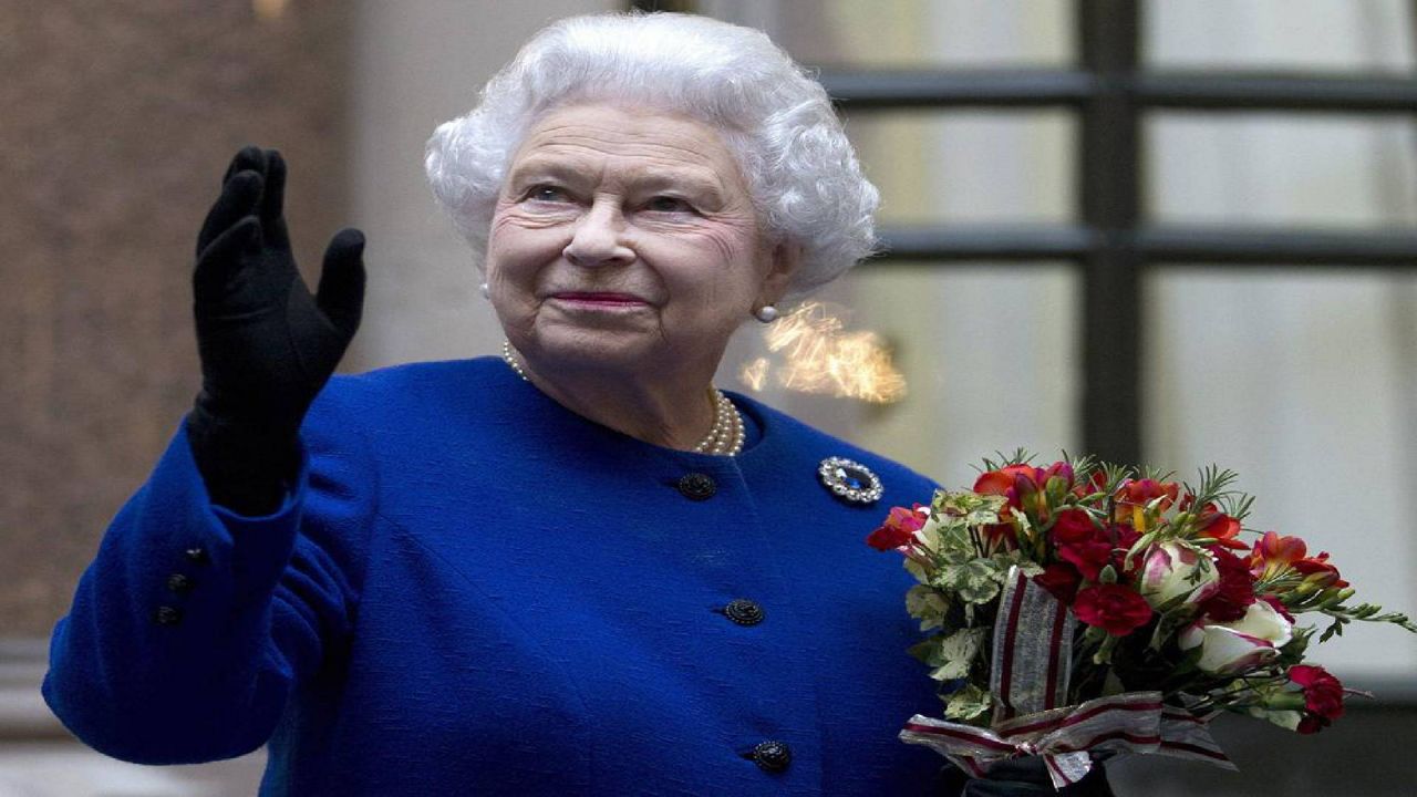 In this Tuesday, Dec. 18, 2012 file photo, Britain's Queen Elizabeth II looks up and waves to members of staff of The Foreign and Commonwealth Office as she ends an official visit which is part of her Jubilee celebrations in London. Queen Elizabeth II, Britain’s longest-reigning monarch and a symbol of stability across much of a turbulent century, has died on Thursday, Sept, 8, 2022. She was 96. (AP Photo/Alastair Grant Pool, File)